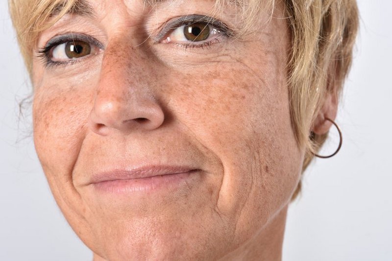 Close-up van een vrouw van middelbare leeftijd, zij kijkt eigenwijs naar de camera, want ze wil niet leren omgaan met hooggevoeligheid, ze wil het oplossen.