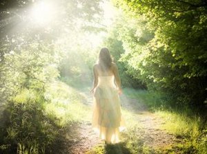 Een hooggevoelige en hoogsensitieve vrouw loopt in het bos te bedenken hoe ze het pleasen kan afleren..