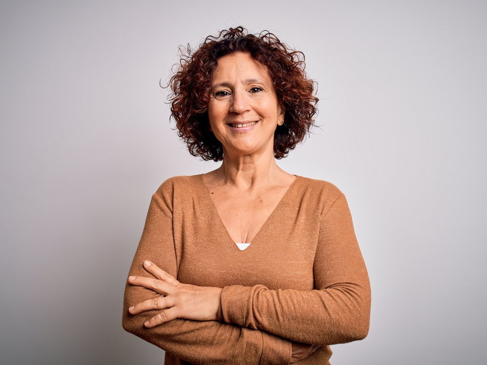 Een vrouw met verborgen hooggevoeligheid kijkt onzeker in de camera
