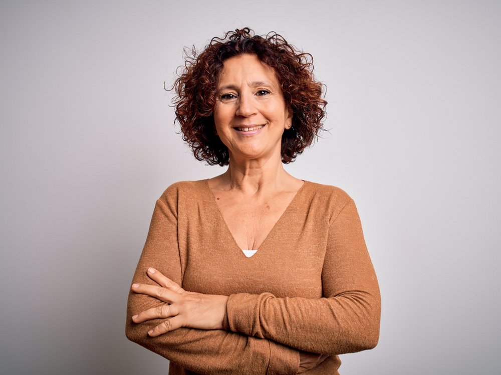 Een vrouw met verborgen hooggevoeligheid kijkt onzeker in de camera